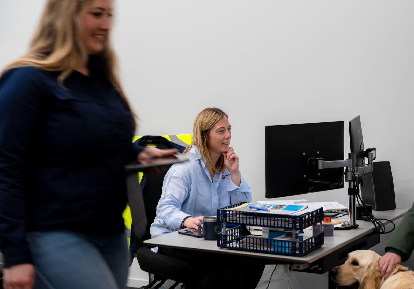 Two team members collaborating at a workstation in the HazNode office