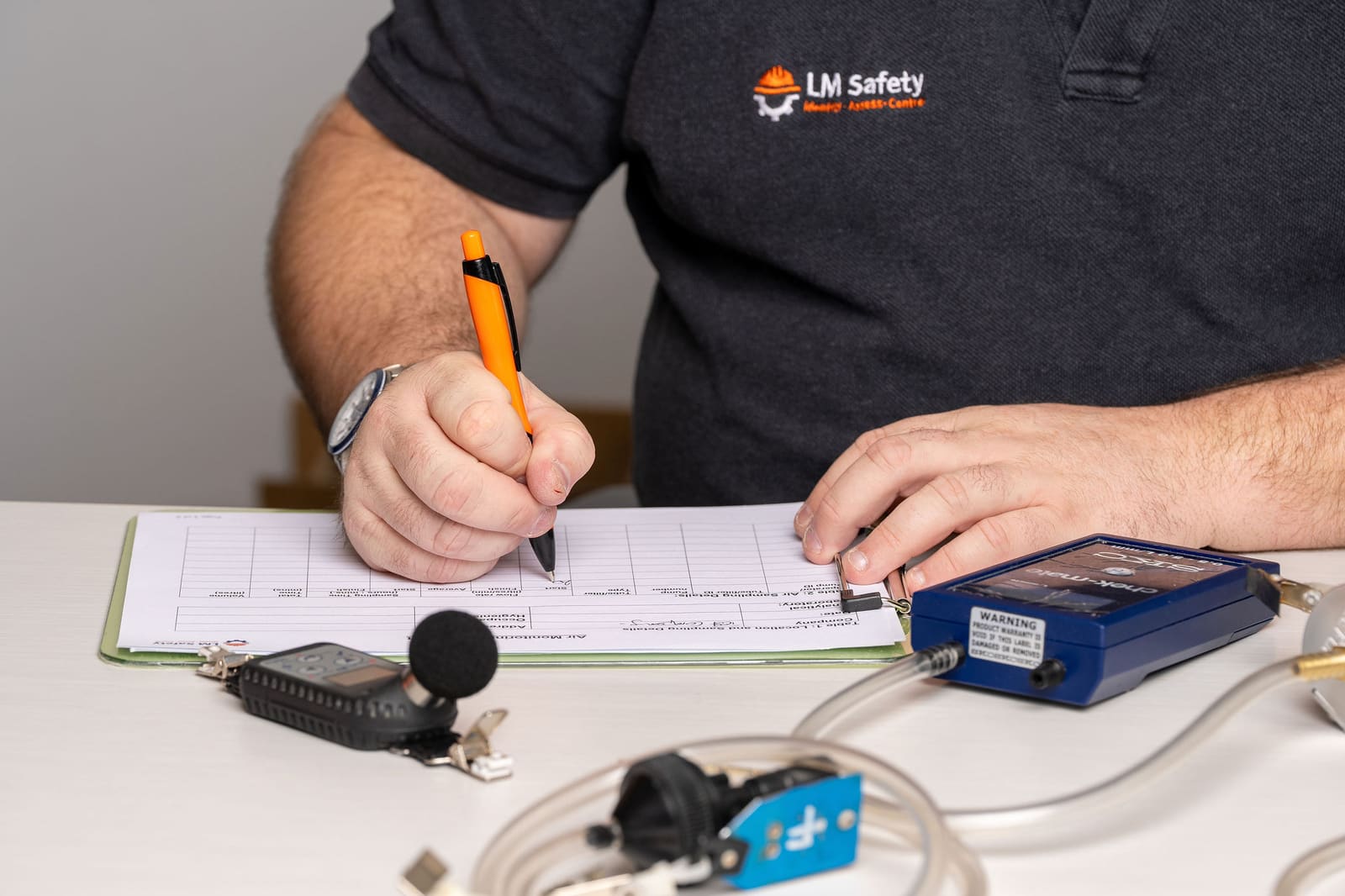Technician recording a pump calibration on a form
